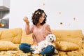 Happy weekends, true positive emotions of young joyful woman with cut curly hair having fun with little dog in falling