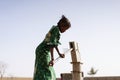 Happy West African Women getting healthful Water in a typical village