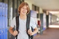 Happy white teenage boy smiling in high school corridor Royalty Free Stock Photo