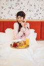 Happy wife having breakfast with rose in bed Royalty Free Stock Photo