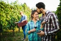 Happy wine grower family walking in vineyard