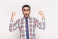 Happy winner handsome bearded businessman in checkered shirt, bl Royalty Free Stock Photo