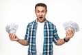 Happy winner man in casual t-shirt smiling with money in dollar banknotes isolated over white background Royalty Free Stock Photo