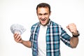 Happy winner man in casual t-shirt smiling with money in dollar banknotes isolated over white background Royalty Free Stock Photo