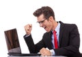 Happy winning business man working on his laptop Royalty Free Stock Photo