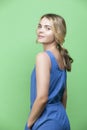 Happy Winsome Caucasian Blond Girl In blue suite Posing In Summer outfit While looking Backwards With Positive Expression Over Royalty Free Stock Photo