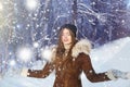 Happy winter fun woman playing throwing snow with arms up open in freedom enjoying the cold season Royalty Free Stock Photo