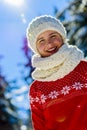 Happy winter girl wearing knitted wear scarf.