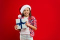 Happy winter holidays. Small girl. Present for Xmas. Childhood. Christmas shopping. Little girl child in santa red hat Royalty Free Stock Photo