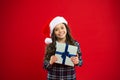 Happy winter holidays. Small girl. Present for Xmas. Childhood. Little girl child in santa red hat. Christmas shopping Royalty Free Stock Photo