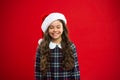 Happy winter holidays. Small girl. Present for Xmas. Childhood. Little girl child in santa red hat. Christmas shopping Royalty Free Stock Photo