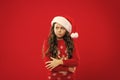 Happy winter holidays. Small girl. Present for Xmas. Childhood. Little girl child in santa red hat. New year party Royalty Free Stock Photo