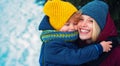 Happy winter. Mom and baby warm hat scarf. Woman with son smiling snowy winter nature background. Christmas and new year Royalty Free Stock Photo