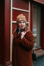 Happy winter time in big city of charming girl walking on street in coat with backpack Royalty Free Stock Photo