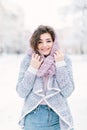 Happy winter time in big city of charming girl walking on street in warm sweater. Enjoying snowfall, expressing Royalty Free Stock Photo