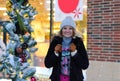 Happy winter time in city of charming girl walking on street enjoying cheerful mood Royalty Free Stock Photo