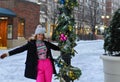 Happy winter time in city of charming girl walking on street enjoying cheerful mood Royalty Free Stock Photo