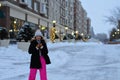 Happy winter time in city of charming girl walking on street enjoying cheerful mood Royalty Free Stock Photo