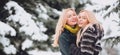 Happy winter woman friends hugging on winter snowy background outdoor. Portrait of young beautiful women couple having Royalty Free Stock Photo