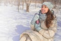 Happy winter woman holding thermo mug with hot beverage walking outdoor natural frozen park Royalty Free Stock Photo