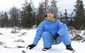 Happy winter young girl observing nature, playing with holiday snow Royalty Free Stock Photo