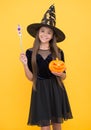 Happy witch child with magic wand and pumpkin jack o lantern wear costume of wizard on halloween party, halloween Royalty Free Stock Photo