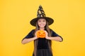 Happy witch child with pumpkin jack o lantern wear costume of wizard on halloween party, halloween tradition Royalty Free Stock Photo