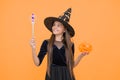 happy witch kid with magic wand and pumpkin jack o lantern wear costume of wizard on halloween party, halloween miracle Royalty Free Stock Photo