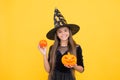 Happy witch kid with pumpkin jack o lantern wear costume of wizard on halloween party, halloween atribute Royalty Free Stock Photo