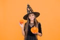 happy witch kid with pumpkin jack o lantern wear costume of wizard on halloween party, halloween atribute Royalty Free Stock Photo