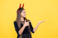 Happy witch teenage devil girl pointing finger on copy space wear imp horns costume on halloween party, halloween party Royalty Free Stock Photo