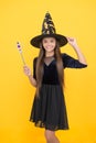 Happy witch teenage girl with magic wand wear costume of wizard on halloween party, halloween