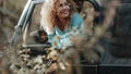 Happy woman admiring nature and forest outside the window of an off road vehicle car. People and adventure travel expedition.