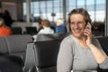 Happy woman at an airport waiting for flight Royalty Free Stock Photo