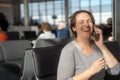 Happy woman at an airport waiting for flight Royalty Free Stock Photo