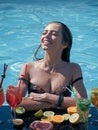 Happy woman with alcoholic beverage and fruit. Cocktail and sexy girl in pool. Summer vacation and party. Swimming and Royalty Free Stock Photo