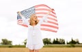 Happy woman with american flag on cereal field