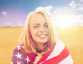 Happy woman in american flag on cereal field