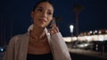 Happy woman answering cellphone call at night street closeup. Girl talking city. Royalty Free Stock Photo