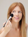 Happy woman applying blusher with brush Royalty Free Stock Photo