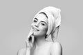 Happy woman applying eye patches. Close up portrait girl with towel on head. Portrait of beauty woman with eye patches Royalty Free Stock Photo