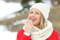 Happy woman applying lip balm outdoors in winter Royalty Free Stock Photo