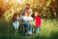 Children run to their disabled mother in the park Royalty Free Stock Photo