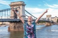 Happy woman arms raised at Chain Bridge, Budapest Royalty Free Stock Photo