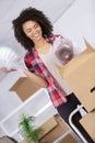Happy woman arranging interior and unpacking at new apartment home Royalty Free Stock Photo