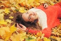 Happy woman autumn portrait, lying in autumn leaves