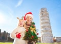 Happy woman and baby girl holding Christmas tree. Pisa, Italy Royalty Free Stock Photo