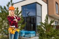 Happy woman on the background of a new house. Portrait of first time buyer, house owner, apartment renter, flat tenant Royalty Free Stock Photo