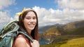 Happy woman with backpack hiking on big sur coast Royalty Free Stock Photo