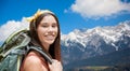Happy woman with backpack over alps mountains Royalty Free Stock Photo